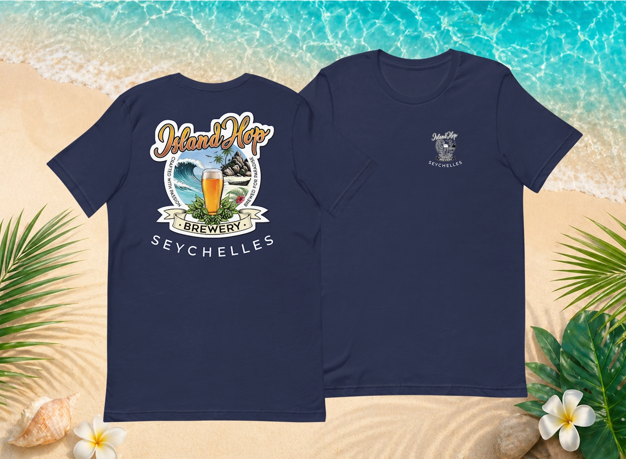 Island Hop Brewery navy t-shirts displayed on a Seychelles-inspired beach sand and turquoise water background.