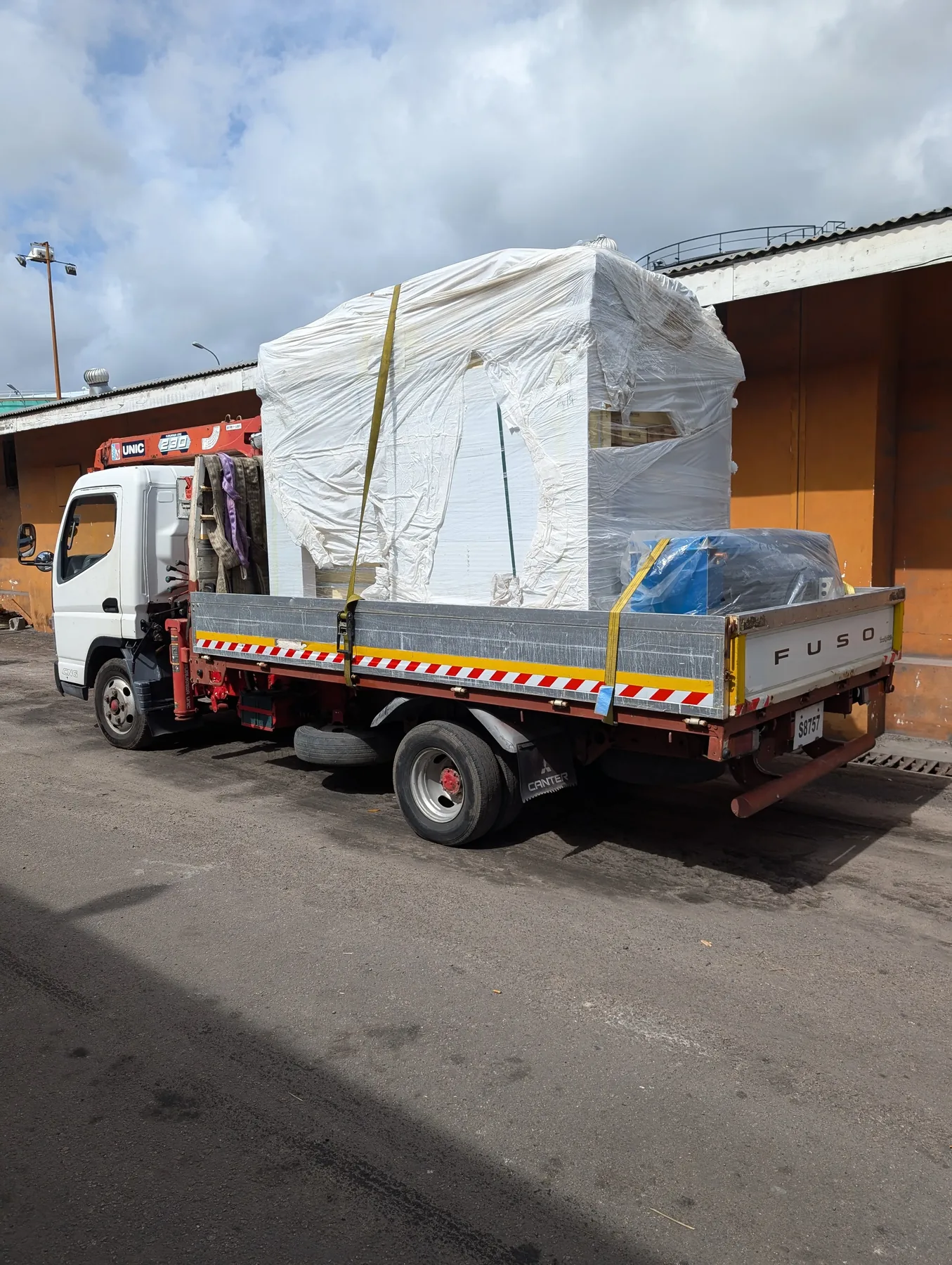 Cold room is loaded at the port before its trip to Island Hop Brewery
